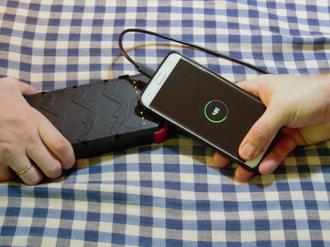 charging a cell mobile phone by connecting to someone elses power bank