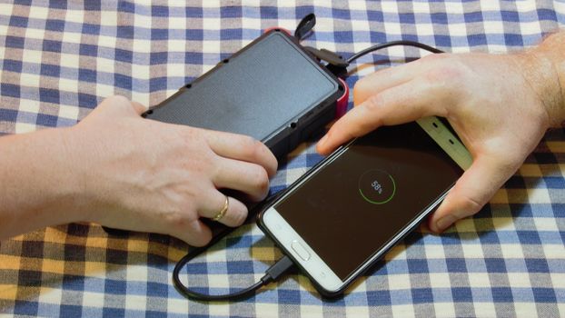 using someone elses solar powered power bank to charge a mobile cell phone