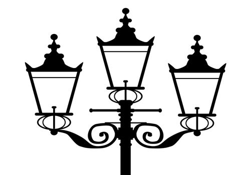 A typical old London gas street light in silhouette