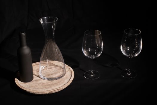 Wine glasses with bottle and pourer. Two wine glasses with wine utensils for the bottle, bottle and decorations