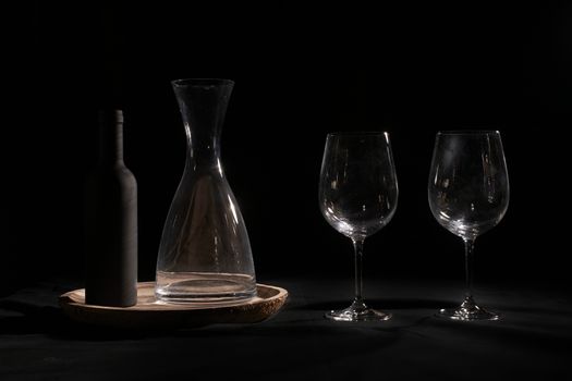 Wine glasses with bottle and pourer. Two wine glasses with wine utensils for the bottle, bottle and decorations