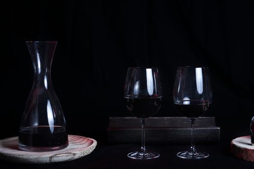 Wine glasses with bottle and pourer. Two wine glasses with wine utensils for the bottle, bottle and decorations