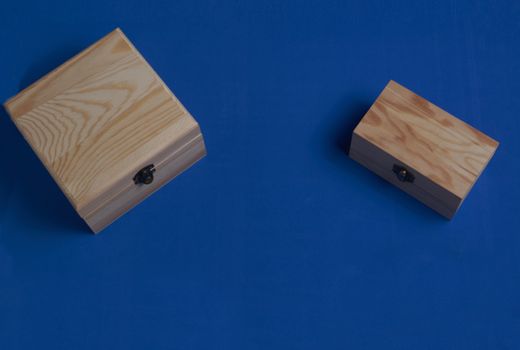Wooden boxes over blue. Secrets and wishes