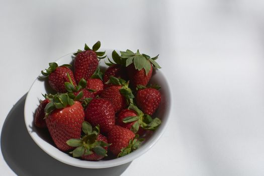 Bowl full of ripe strawberries ready to eat. Colors of nature