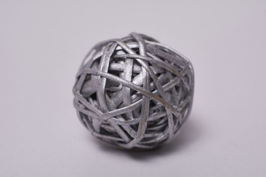 Macro photography of ball made of silver painted straw, closeup and detail of straw