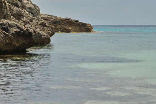 Rock in a creek with blue sky. blue sea