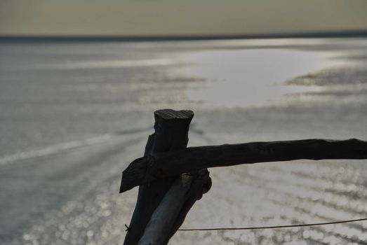 Looking at the sea from the railing. The sunset