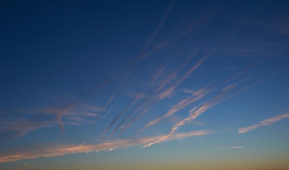 Intense blue sky with small white clouds