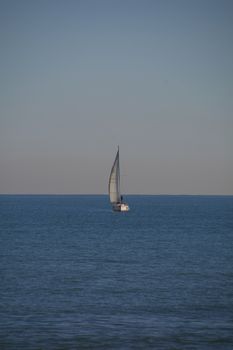 Sailboat in the blue symmetrical calm mediterranean