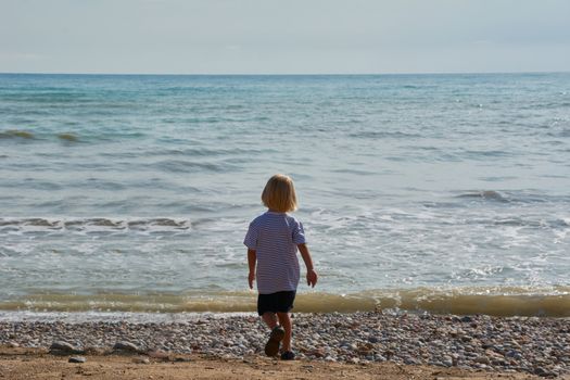 Children looking at the calm and blue beach