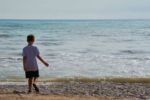 Children looking at the calm and blue beach