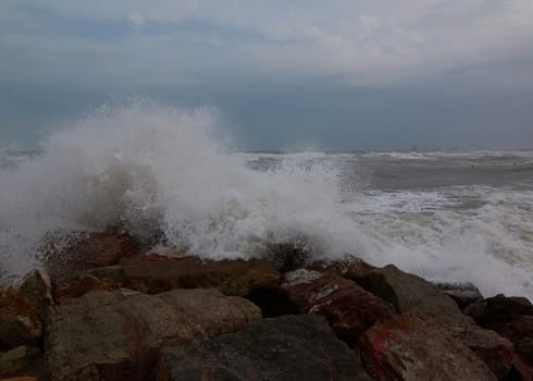 The breaking of the waves on the beach. Storm colors