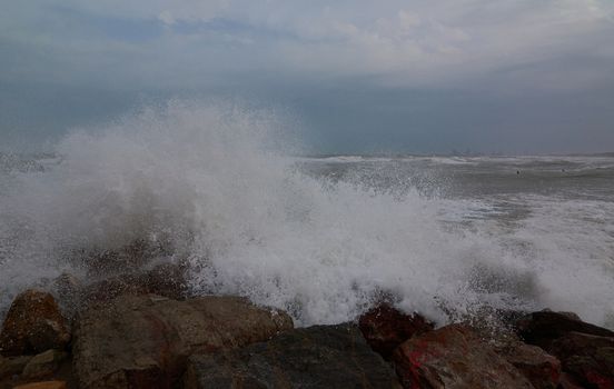 The breaking of the waves on the beach. Storm colors