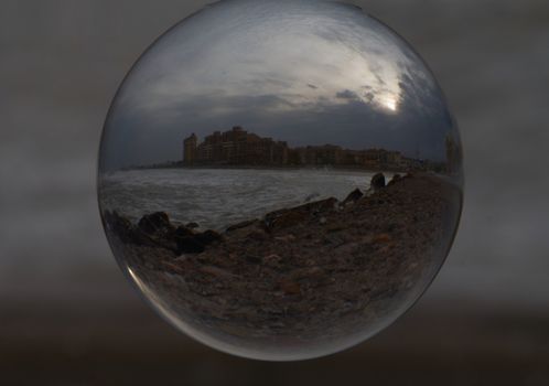 Reflections of the beach on the ball. Storm colors