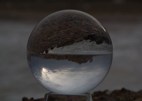 Reflections of the beach on the ball. Storm colors