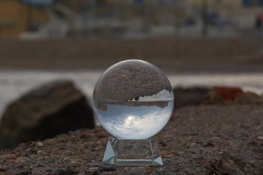 Reflections of the beach on the ball. Storm colors