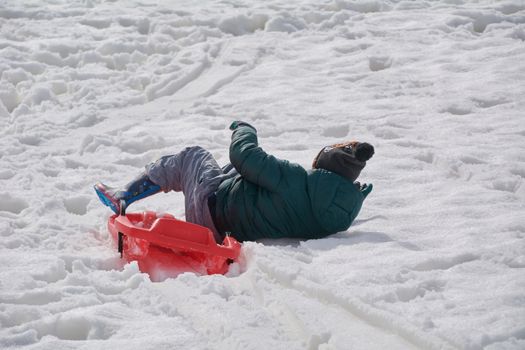 Playing with the sled in the snowy mountain