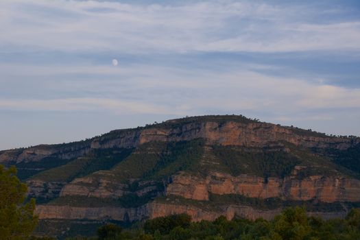 The big mountain with the moon one summer day.Loneliness and tranquility