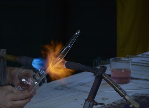 Skilful hands shaping hot and dangerous glass. ancient traditions