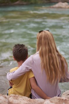 Mother and son watching the mighty river, Mothers love