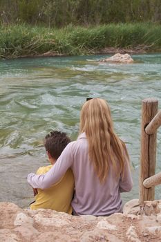 Mother and son watching the mighty river, Mothers love