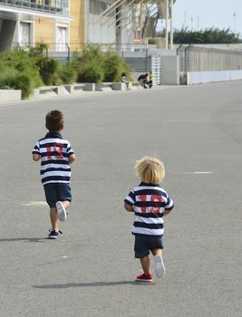 Children preparing for a fun street race. Friendship and love