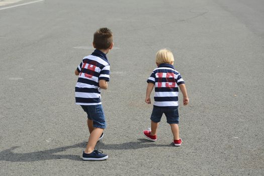 Children preparing for a fun street race. Friendship and love