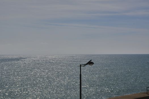 Lamppost on a bright day by the sea. Colors of nature