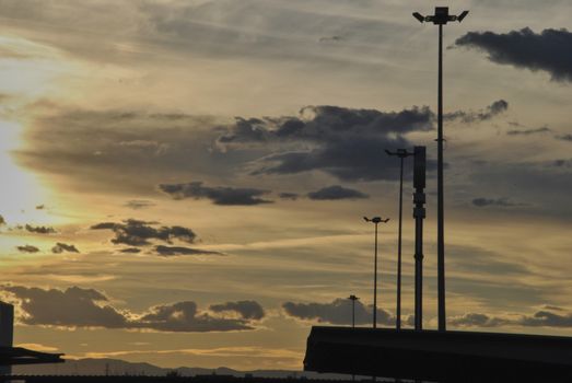 Sunset of a spring day among the street lamps. Colors of nature