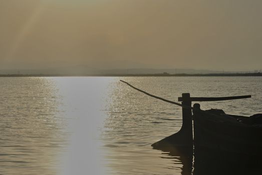 Back of a small boat on a lake. silhouettes. Colors of nature