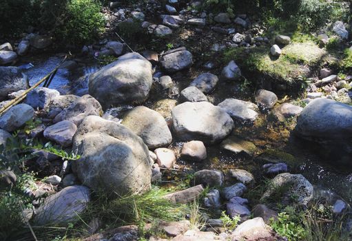 Several rocks in the one river between the mount. Colors of nature