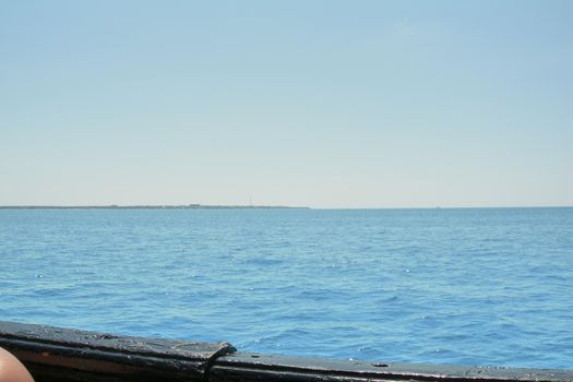 View of the Caribbean Sea from the deck of the ship.Turquoise waters and cloudless blue sky