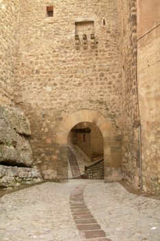 Lonely street of a medieval town, cobbled streets, arched door, lonely