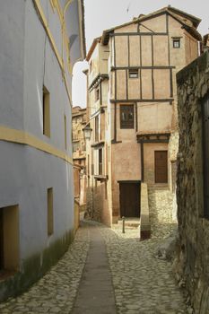 Lonely street of a medieval town, cobbled streets, arched door, lonely