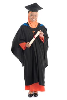 Full body female student in graduation gown, standing isolated white background.