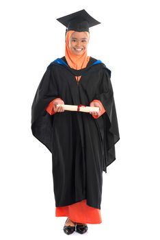 Full body female student in graduation gown, standing isolated white background.