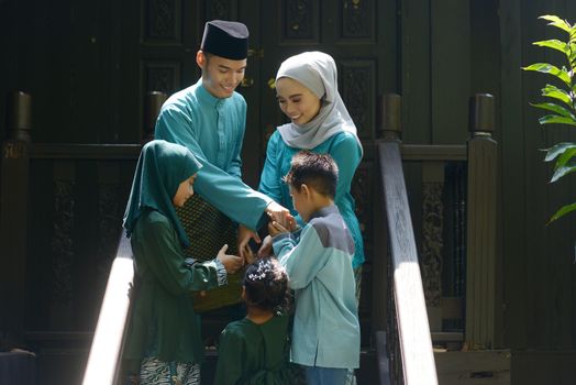 Muslim family greeting, Hari Raya Eid Al-Fitr concept. 