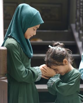 Muslim children greeting, Hari Raya Eid Al-Fitr concept. 