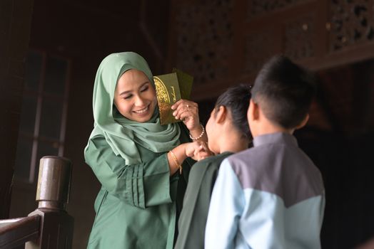 Muslim family greeting, Hari Raya Eid Al-Fitr concept. 