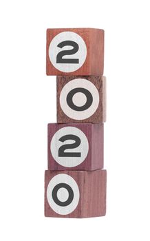 Four isolated hardwood toy blocks on white, saying 2020