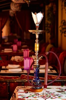 Wood hookah on table in hookah lounge. Shallow dof