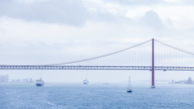 Ships and boats traverse the River Tagus beside the port of Lisbon in Portugal.