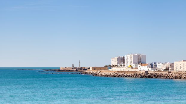 The Cadiz waterfront in Spain with the Castillo de San Sebastian in the background.