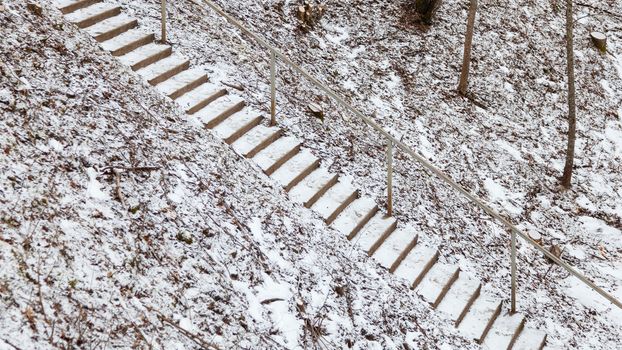 A view of snow covered and icy stone steps.  The steps are located in the Gauja River Valley near Sigulda, Latvia.