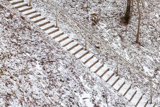 A view of snow covered and icy stone steps.  The steps are located in the Gauja River Valley near Sigulda, Latvia.
