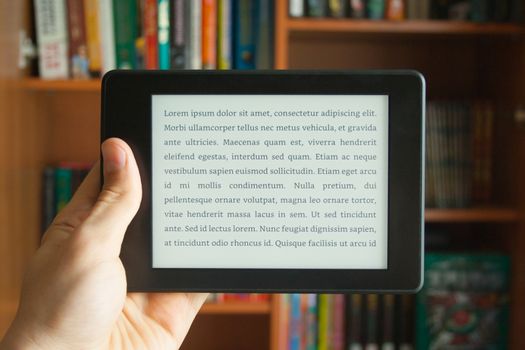 E-book in man's hand with lorem ipsum text