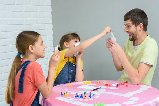 Children draw dad's card in a fun board game