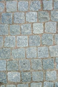 Old aged granite paving stones. Texture of old granite paving stones. The texture of the pavement granite pattern wallpaper for design. Rough texture
