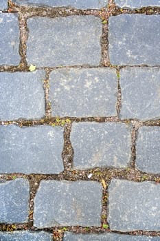 Old aged granite paving stones. Texture of old granite paving stones. The texture of the pavement granite pattern wallpaper for design. Rough texture vertical
