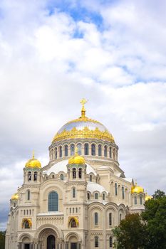 Nicholas the wonderworker's church on Anchor square in kronstadt town Saint Petersburg. Naval christian cathedral church in russia with golden dome, unesco architecture at sunny day vertical picture